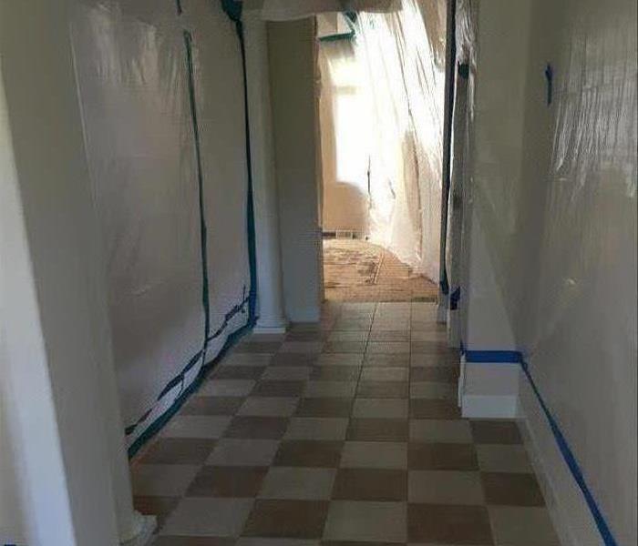 Containment along walls in hallway.