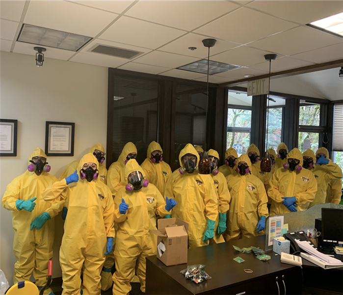 several men in yellow suits and face masks